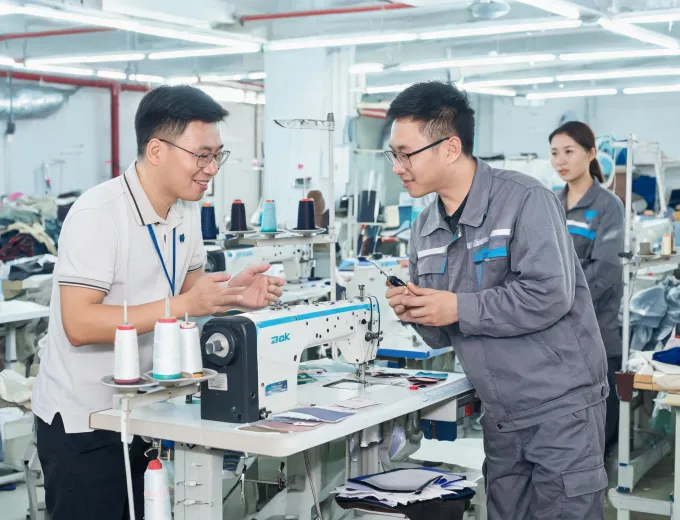 Technician adjusting an industrial sewing machine
